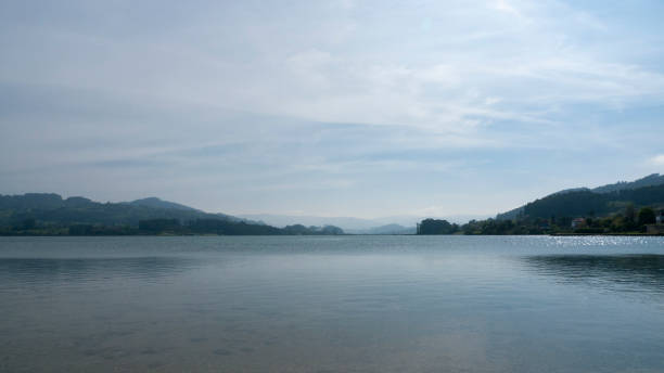istock Lake horizon in haze 1396066549