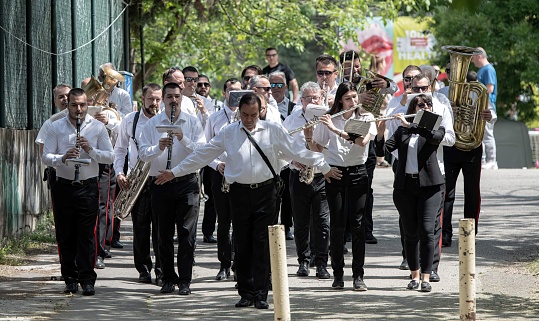 Skopje, Macedonia - 05 08 2022: a music band marching through a public park in Skopje