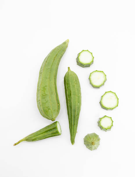 Fresh Angled loofah or Ridge gourd (Ribbed Gourd) with sliced isolated on white background. stock photo