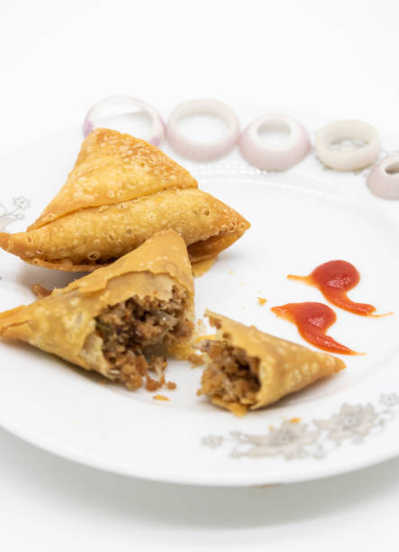 istock Samosa in a plate with chili and onion isolated on white background, 1396070822