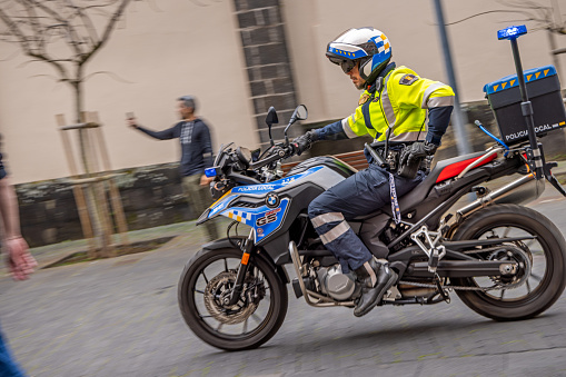 Police officer on a motor bike in a pedestrian street in La Laguna which used to be the main city on the Spanish Canary Island Tenerife