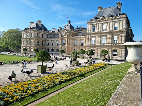 The Jardin du Luxembourg (Luxembourg Garden), is located in the 6th arrondissement of Paris, France. Creation of the garden began in 1612. The image shows the the gardens during a warm day in springtime in front of the Luxembourg Palace.
