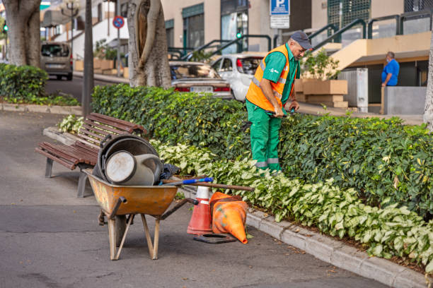 Gardener working in a public park in the center of Santa Cruz which is the main city on the Spanish Canary Island Tenerife