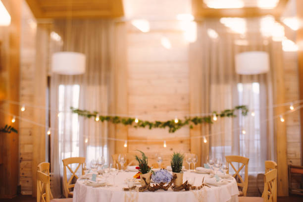 istock Table setting at wedding reception in the evening. Floral composition on decorated dining table. 1396074881
