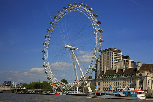 London, United Kingdom - May 10, 2011: London Eye in afternoon sun. The giant Ferris wheel is 135 meters tall and the wheel has a diameter of 120 meters.