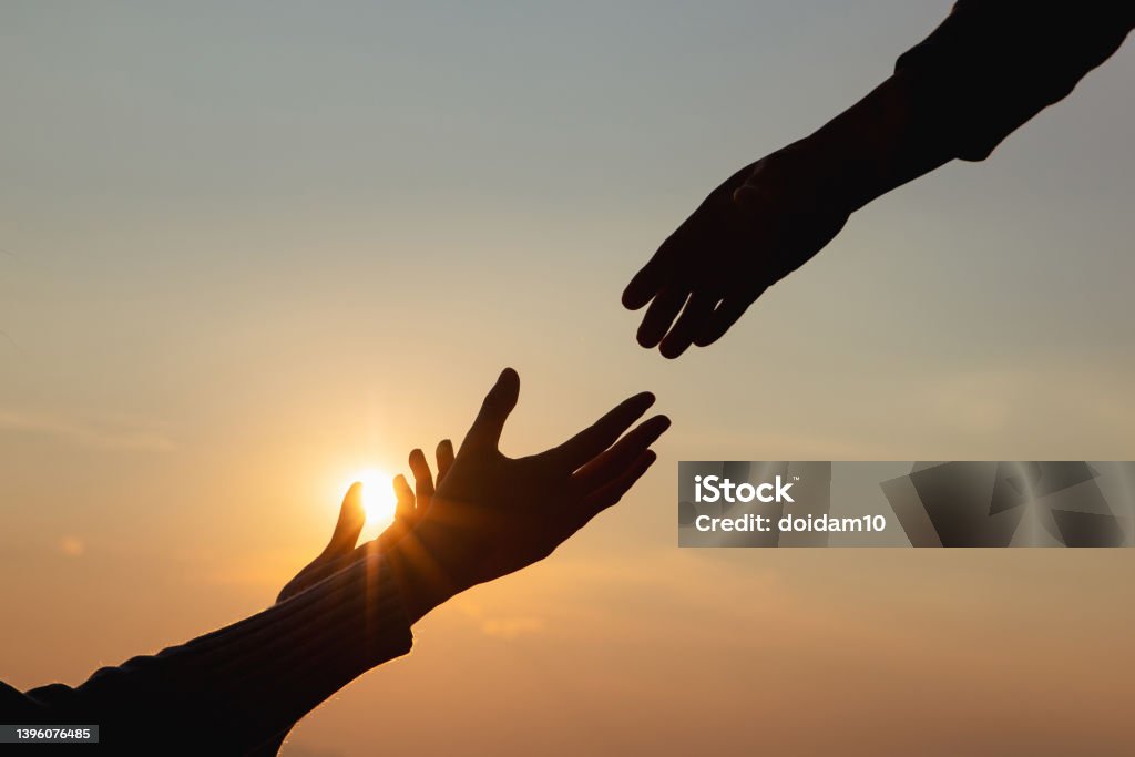 Giving a helping hand Giving a helping hand on the background of the dawn Minister - Clergy Stock Photo