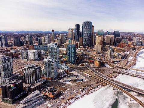 Downtown Calgary and frozen Bow River during winter. City of Calgary aerial view. Alberta, Canada.