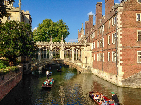 Cambridge, England- September 7, 2014: The campus of Universty of Cambridge is almost the most beautiful one in the world. Here is students punting in River Cam, close to the Bridge of Sighs, St. John's College.