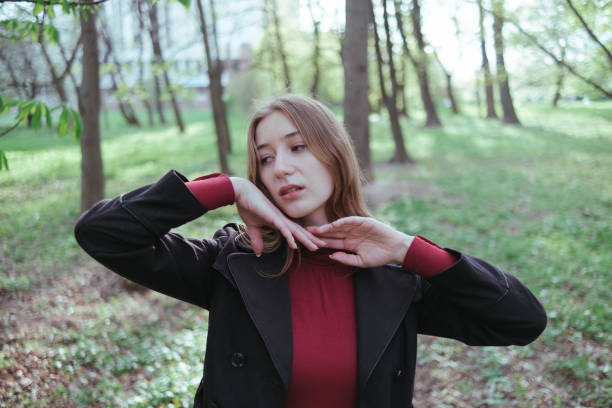 istock a girl in red golf and a black jacket enjoys spring in the forest 1396078324