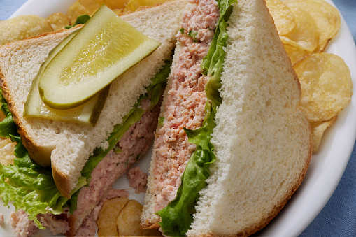 Classic Retro Style Deviled Ham Salad Sandwich on White Bread with Lettuce, Dill Pickles and Potato Chips