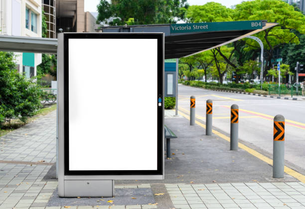 istock Billboard mock up in suburb background. Template of an empty information billboard near roadside with clear road, Mock-up of a city banner placeholder and poster. 1396080043