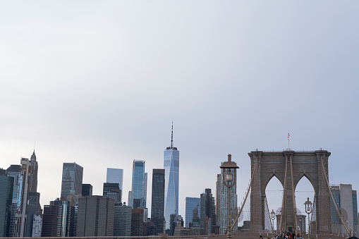 The Famous Brooklyn Bridge at Sunrise, New York City, USA. The sun is rising over Brooklyn on this beautiful day of Autumn