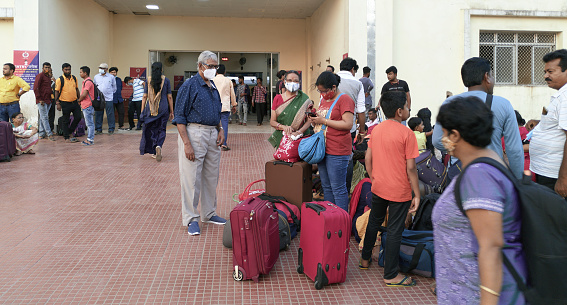 Santragachi, Howrah, 04/10/2022: Train travellers (wearing protective face masks) with their luggage (mostly backpack and trolley bags) waiting outside Santragachi junction Railway Station.
After long days of lockdown restrictions, people are slowly adopting to new normal, hence more people are beginning to travel.