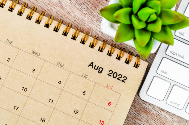 istock August 2022 desk calendar with keyboard computer on wooden background. 1396081715