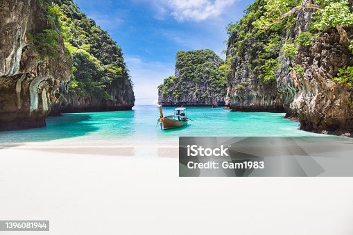 istock Thai traditional wooden longtail boat and beautiful beach in Phuket province, Thailand. 1396081944