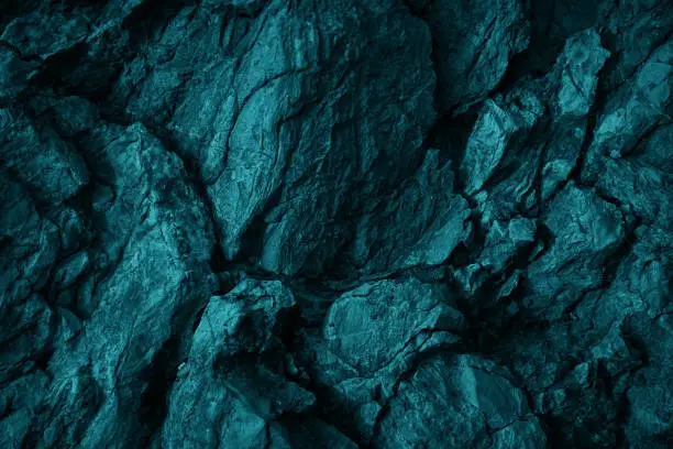 Photo of Green blue rock texture. Toned rough mountain surface texture. Crumbled. Close-up.