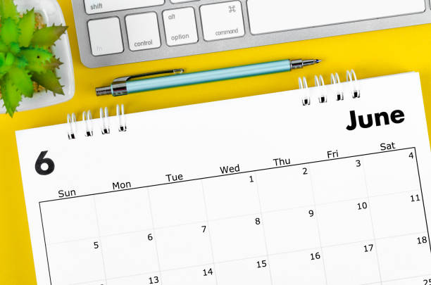 istock June 2022 desk calendar with pen and keyboard computer on yellow background. 1396083807