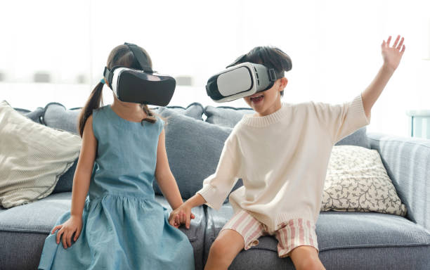 istock Asian child feeling excited while using 360 VR headset for virtual reality, Metaverse at home. 1396087274