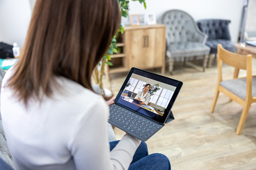 Woman consulting with a doctor through web conference - telemedicine