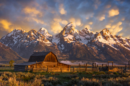 A scenic sunrise over the iconic John Moulton barn in the Mormon Row district of the Grand Teton National Park in Wyoming