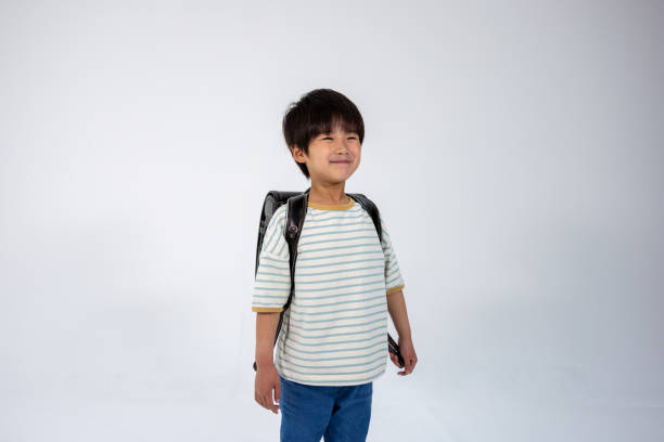 istock Portrait of elementary school child smiling with white background 1396089082
