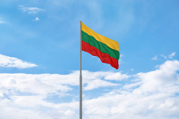 istock Lithuanian flag in front of blue sky and clouds. 1396093108