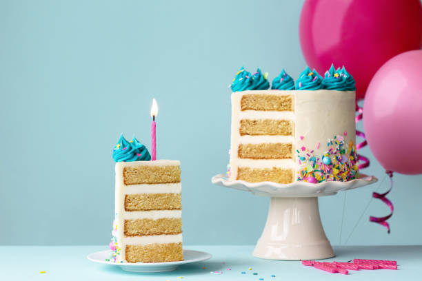 istock Birthday cake with slice removed and pink candle 1396093483