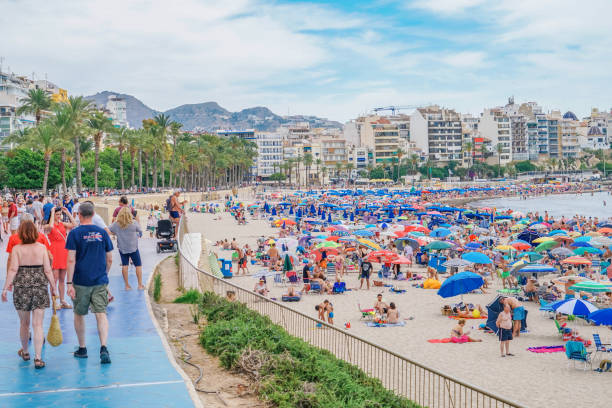 Benidorm, Spain, 16 June, 2019: View of Benidorm Poniente beach full of resting people in Benidorm, Spain stock photo