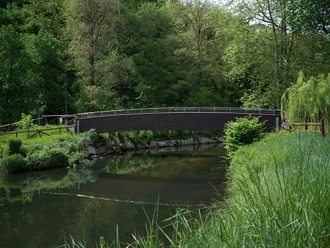 A small wooden bridge spans the river Leyre in Le Teich near Arcachon