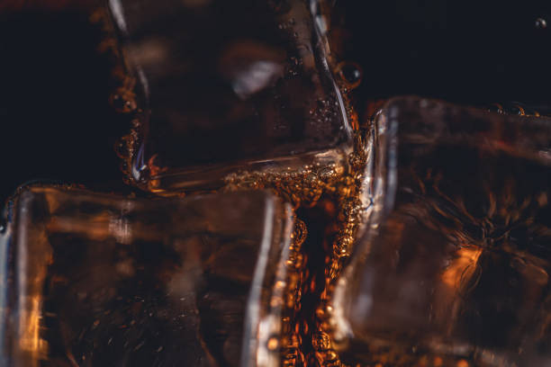 istock Drink Poured Into Glass With Ice Cubes 1396095898
