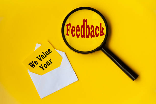 Top view of text - we value your feedback on notepad and magnifying glass. Conceptual