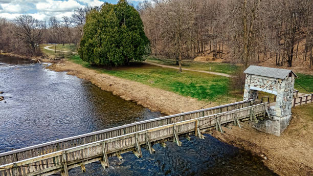 istock A spring day at the park with a cloudy day over the bridge over the river 1396097441