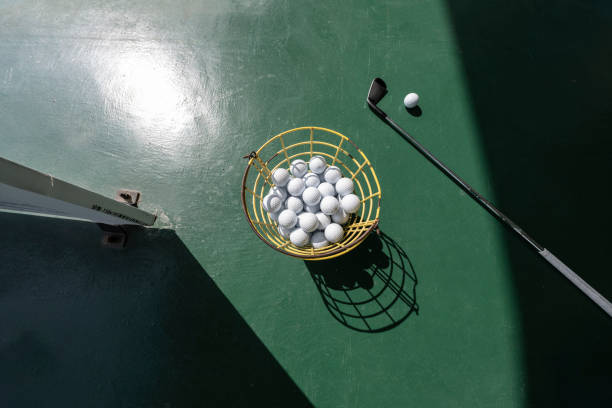 Looking down at golf balls and clubs