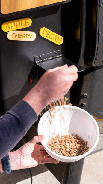 istock Man opens small hopper door to drain pellets 1396102947