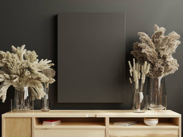 istock Mockup poster frame on cabinet in living room interior on empty dark wall. 1396103842