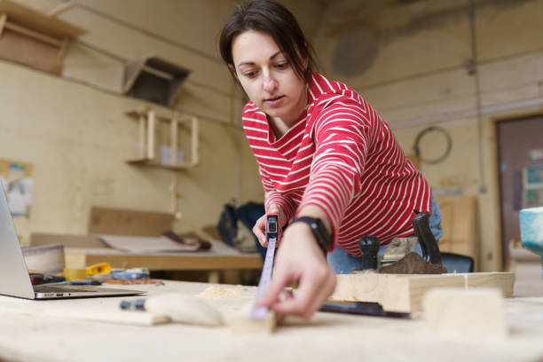 istock carpenter girl in a red jacket 1396104733