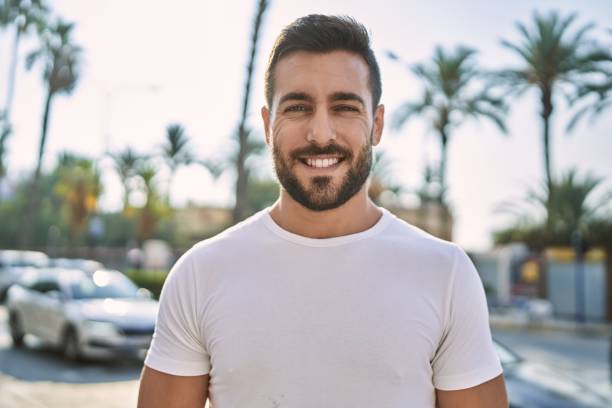 istock Young hispanic man smiling confident walking at street 1396105089