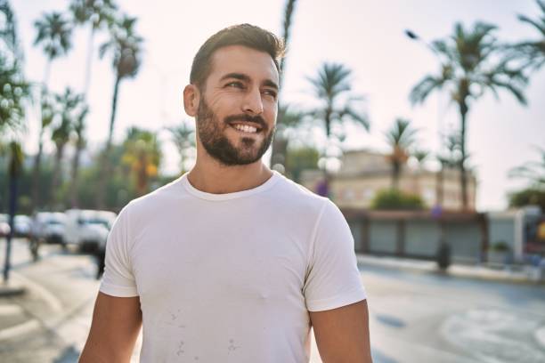 istock Young hispanic man smiling confident walking at street 1396105095