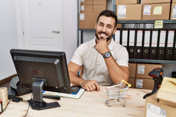 istock Handsome hispanic man working at small business commerce looking confident at the camera smiling with crossed arms and hand raised on chin. thinking positive. 1396105119