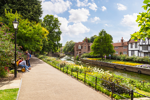 Canterbury, UK, July 16, 2017; People sitting and walking in the beautiful flowered westgate garden Canterbury, England.
