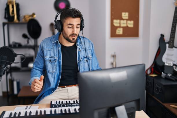 istock Young hispanic man artist smiling confident having video call at music studio 1396105273