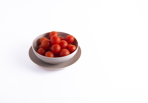 Cherry tomatoes, isolated on white background, with copy space.