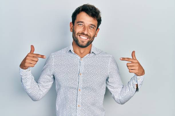 istock Handsome man with beard wearing casual elegant shirt looking confident with smile on face, pointing oneself with fingers proud and happy. 1396106572