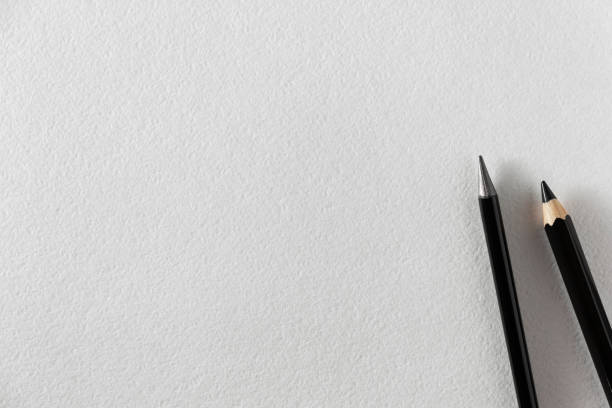 istock Paper mockup. Watercolor A4 paper with black pencils. 1396110559
