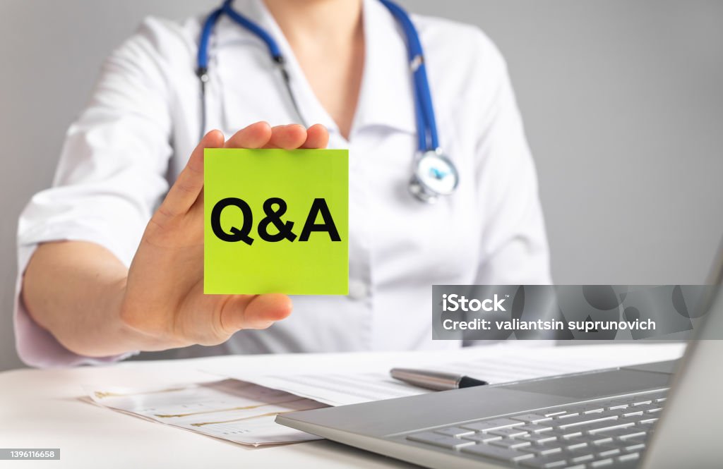 Doctor holding card with q a letters. FAQ in medicine and health care concept. Woman in lab coat answering patients questions online Doctor holding card with q a letters. FAQ in medicine and health care concept. Woman in lab coat answering patients questions online. High quality photo Q and A Stock Photo