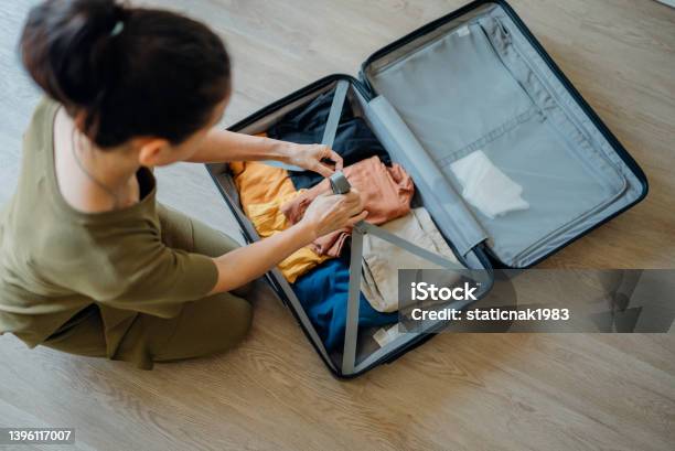 Woman Packing Suitcase At Home For Journey In Vacation Day Stock Photo - Download Image Now