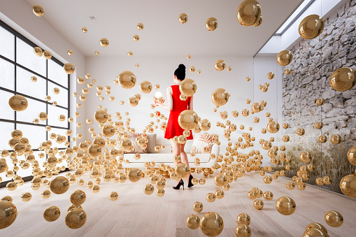 Exploding sphere in living room with woman standing. This is 3D generated image.