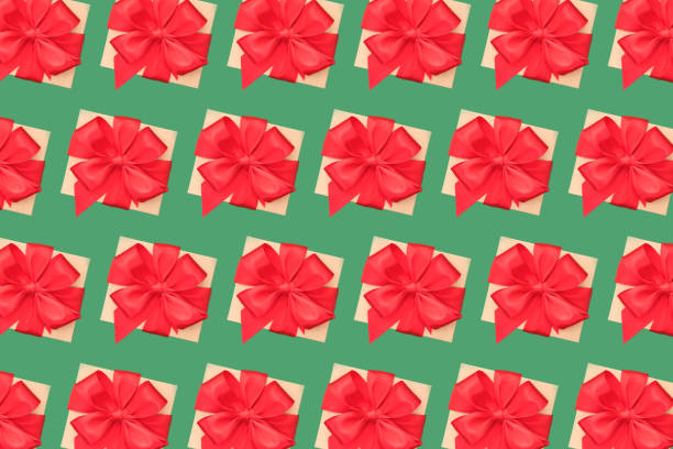 istock Flatlay composition with many present boxes with red ribbon bow on green background. Birthday or Christmas gift concept, top view. Festive Christmas background 1396119265