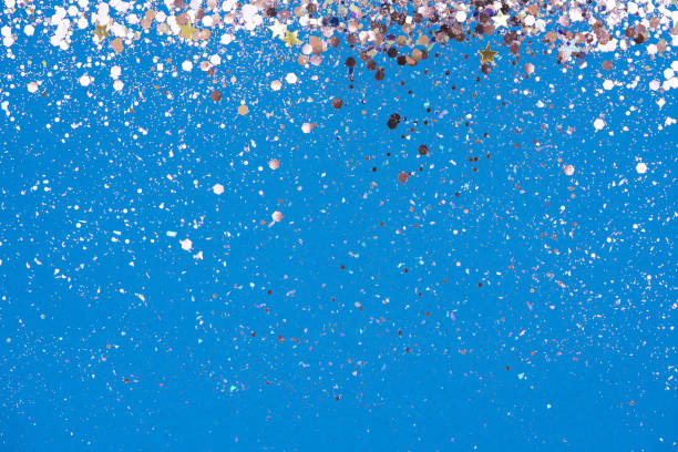 Festive abstract background with sparkles and glitter on blue. Shiny backdrop with copy space for your project