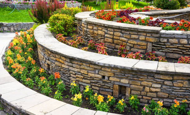 Landscaping with retaining walls and flowerbeds in residential house backyard stock photo